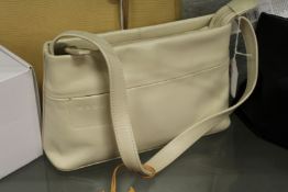 A Radley beige leather handbag with dust cover.