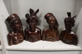 Four good carved hardwood Indonesian busts.