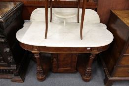 A Victorian mahogany and marble top wash stand the ornate base with cupboard.