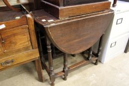 An oak drop leaf gate leg table and an oak bureau.
