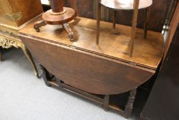 An oak drop leaf gate leg dining table.