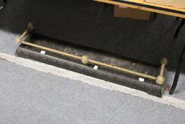 A brass and cast iron fender.