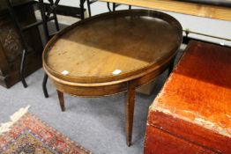 A George III style mahogany tray top oval coffee table.