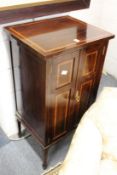 An Edwardian inlaid mahogany pedestal cupboard.