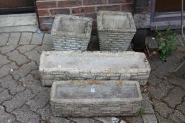 A pair reconstituted stone garden planters and two similar garden troughs.