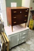 A three drawer chest and an old painted kitchen cabinet.