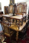 A set of twelve Indian hardwood dining chairs, two with arms, all with canework backs and seats,
