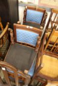 A set of four Victorian walnut and upholstered dining chairs.