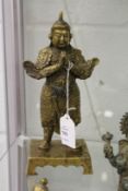 A bronze statue of a Chinese warrior or guardian.