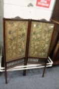 A Chinese folding dressing screen with floral decorated panels.
