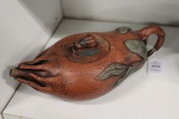 A gourd shaped Chinese terracotta teapot.