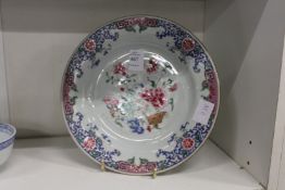 A Chinese Famille Rose circular plate (repaired).