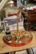 Tiger beer, an unusual bar top display item with a porcelain tiger, a bottle of beer under a palm