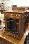 An Edwardian inlaid mahogany small cabinet.