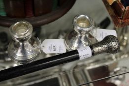 A pair of silver dwarf candlesticks and a silver mounted part walking stick.