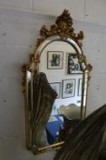 A decorative gilt framed mirror.