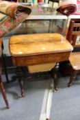 A Victorian figured walnut and inlaid work / writing table with fitted interior, on turned