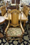 A set of eight oak high back dining chairs, two with arms.