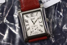 A stainless wristwatch with leather strap.