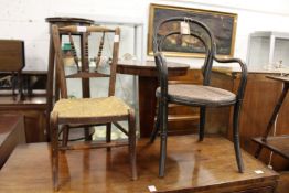 A Thonet bentwood child's armchair together with a child's rush seated chair.