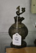 A small eastern bronze vessel mounted with a bird.