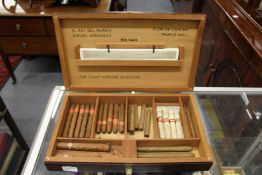A humidor containing various cigars.