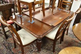 A good Victorian style mahogany extending dining table with two leaves.