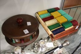 Gaming chips, housed in a circular wooden case, together with a box of gaming chips.