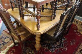 An Indian carved hardwood extending dining table with one leaf, supported on barley twist legs (made