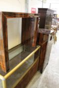 An unusual glass console table and a pair of matching cabinets.