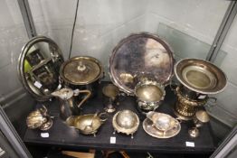 A campagna urn shaped plated champagne bucket, a decorative mirror with a silver plated frame, and