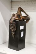 A good modern bronze female reclining nude on a square shaped pillar.