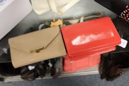 L. K. Bennett, a beige patent leather clutch bag with dust cover together with a Hobbs coral