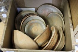 A quantity of old Chinese terracotta bowls.