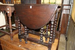 An oak drop leaf gate leg table.
