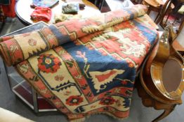 A large Persian style carpet with broad geometric design.