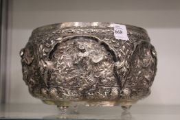 A good Indian white metal repousse bowl, tests as silver, decorated with panels of dancing figures