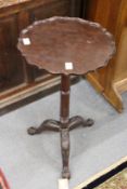 A George III design mahogany tripod candle stand with piecrust top.