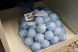 A bag of fifty Srixon soft feel golf balls.