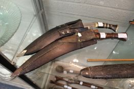 An Indian Army Gurkha kukri with original scabbard together with a reproduction kukri.