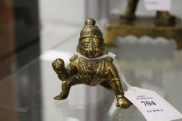 A small bronze figure of baby Krishna.