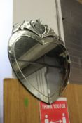 A heart shaped Venetian style mirror.
