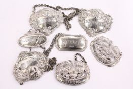 Three silver and four plated wine labels.