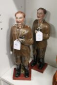 A pair of pottery figures depicting Russian military men.