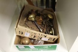 Two boxes of brass and other door furniture.