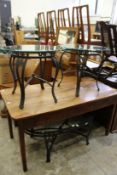 A pair of wrought iron and glass circular lamp tables together with a matching oval coffee table.