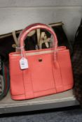 A ladies' pink leather handbag.