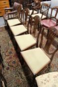 A set of four mahogany shield back dining chairs.