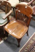An Edwardian mahogany desk chair.
