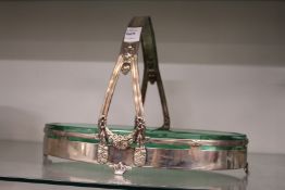 An Art Nouveau design plated basket with green glass liner.